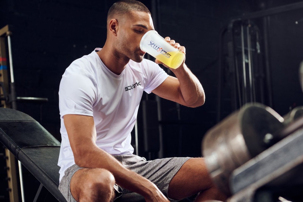 gym athlete drinking pre-workout